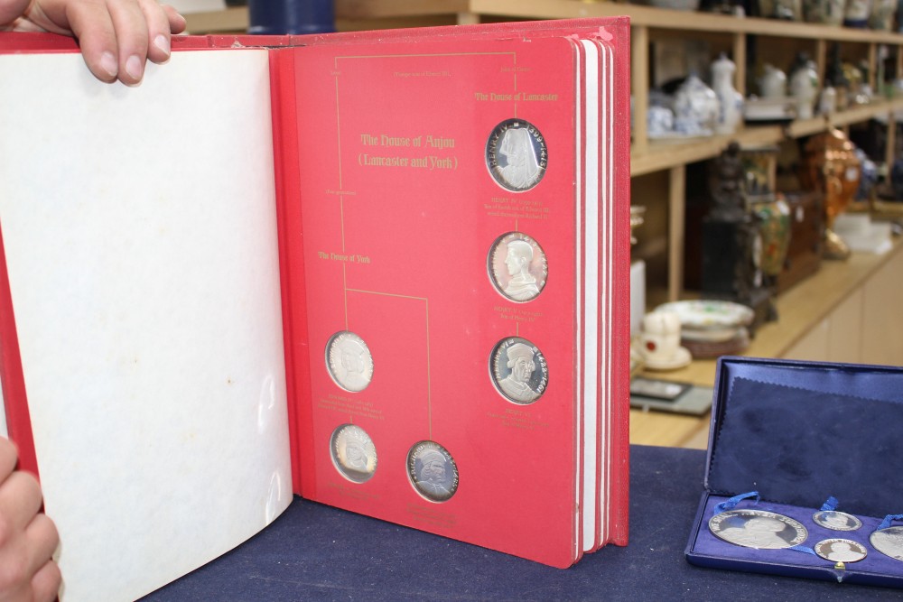 A set of the Kings and Queens of England sterling silver proof medallions, housed in original album and three other cased sets